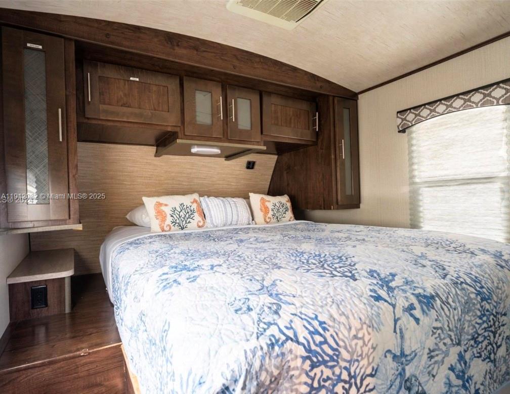 325 Calusa Street, Unit 118 Key Largo, FL 33037 - Photo 9 of 18 a bed sitting in a bedroom next to a window