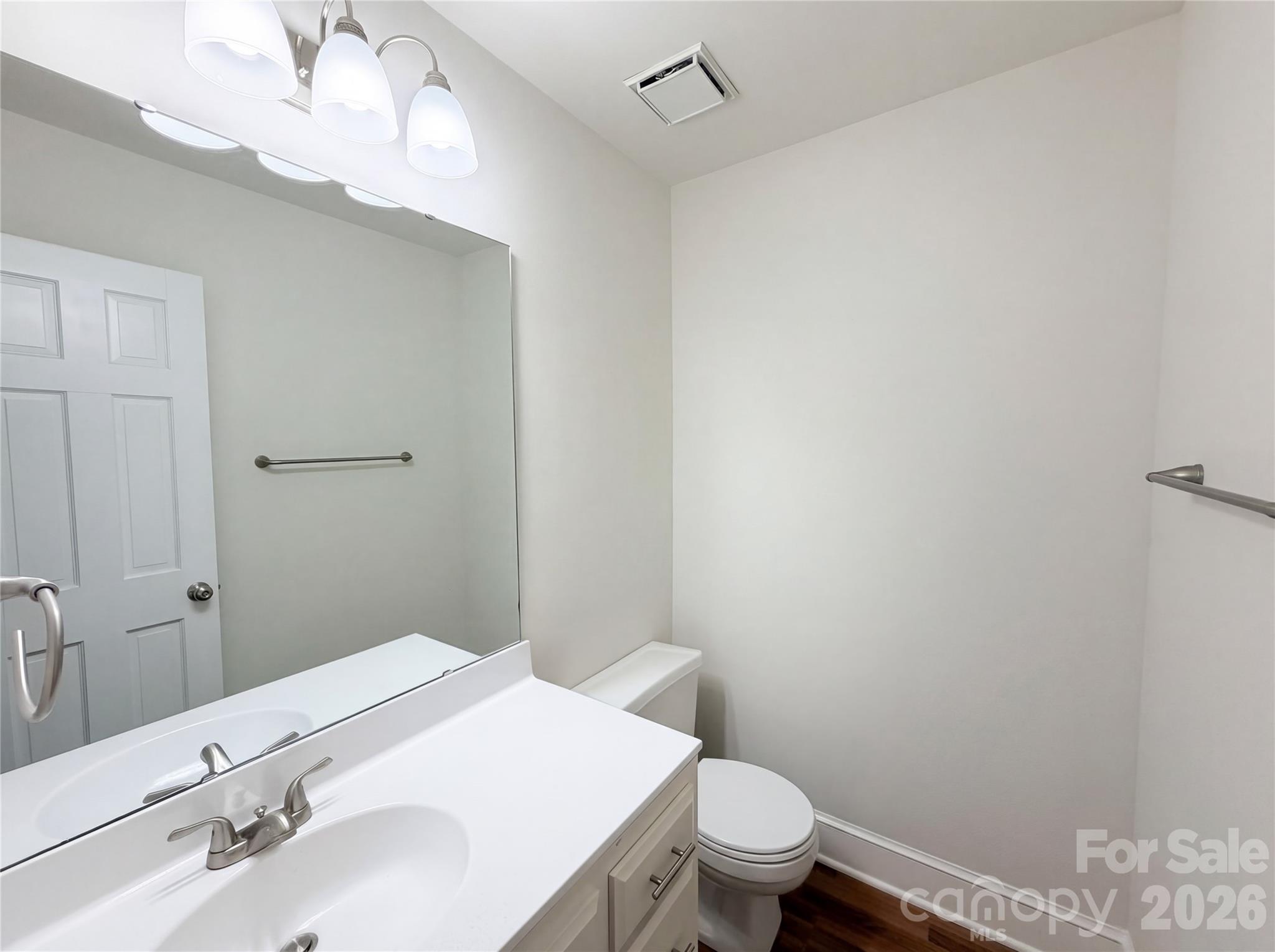 6024 Dovefield Road Charlotte, NC 28277 - Photo 14 of 17 a bathroom with a sink a toilet and vanity