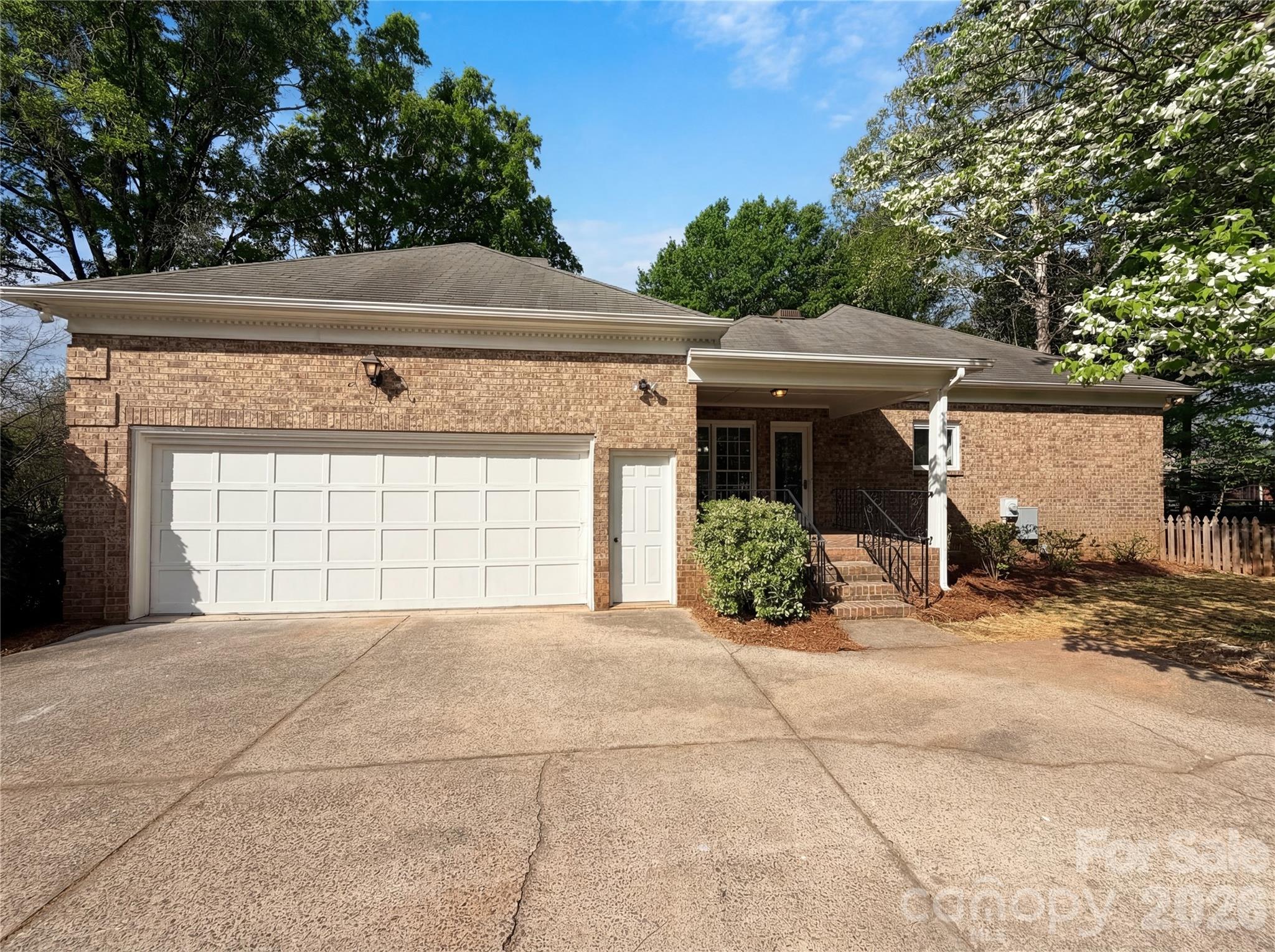 6024 Dovefield Road Charlotte, NC 28277 - Photo 2 of 17 a front view of a house with a yard and garage