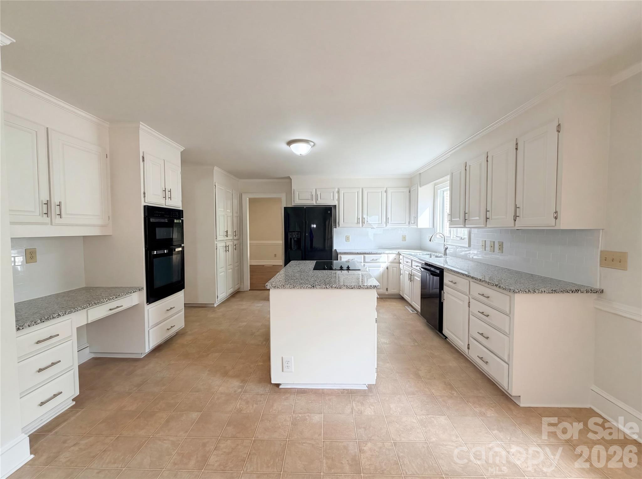 6024 Dovefield Road Charlotte, NC 28277 - Photo 8 of 17 a large white kitchen with stainless steel appliances granite countertop a stove a sink a refrigerator and white cabinets
