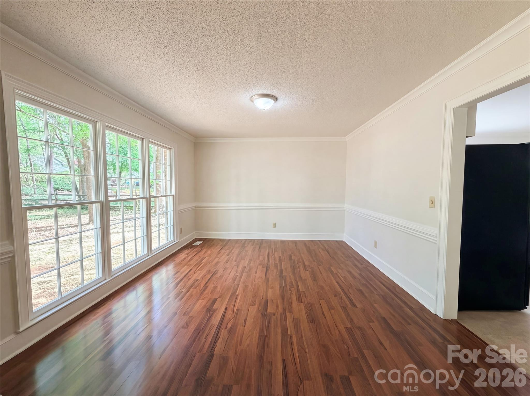 6024 Dovefield Road Charlotte, NC 28277 - Photo 9 of 17 wooden floor in an empty room with a window