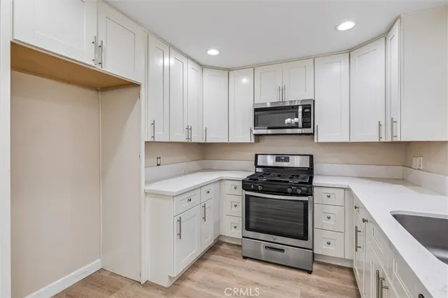 a kitchen with a sink cabinets and window