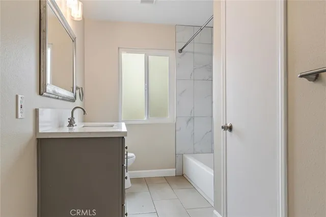 a bathroom with a sink vanity toilet and a mirror