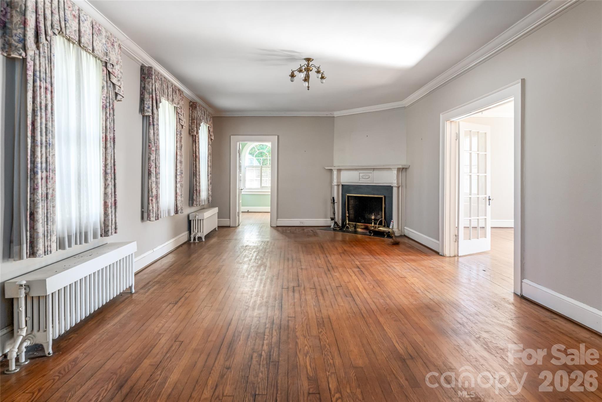 325 Vanderbilt Road Asheville, NC 28803 - Photo 12 of 48 a view of a livingroom with wooden floor and a fireplace