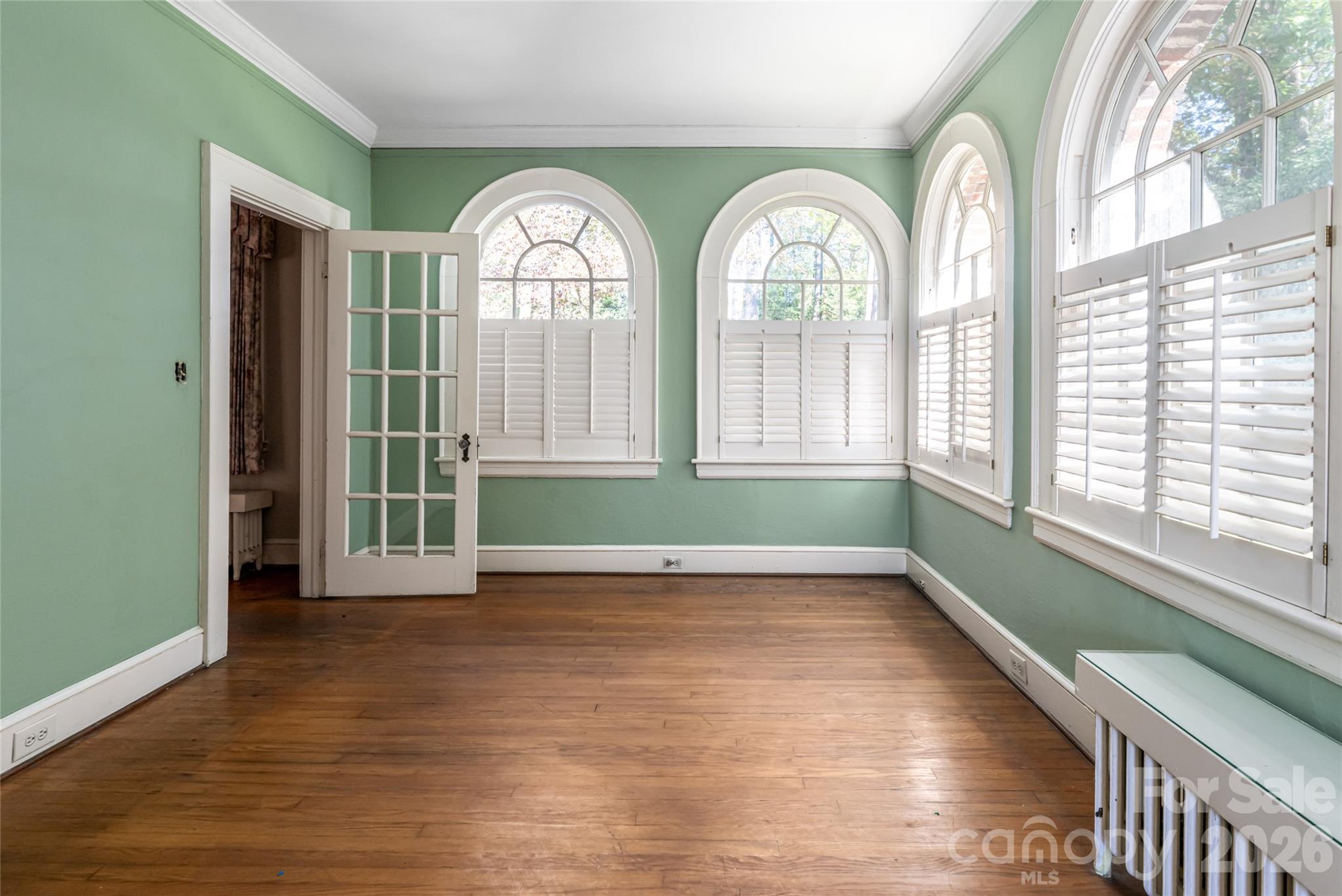 325 Vanderbilt Road Asheville, NC 28803 - Photo 24 of 48 a view of an empty room with wooden floor and a window