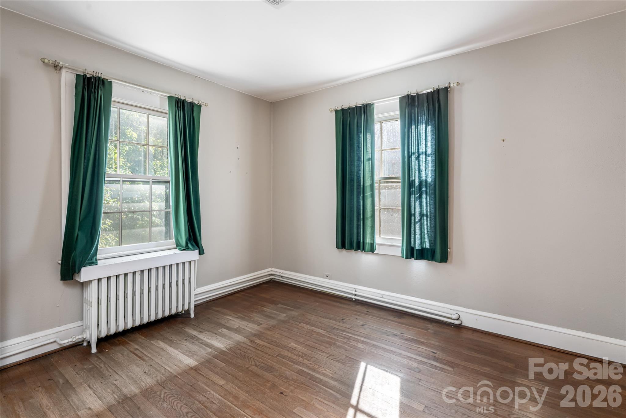 325 Vanderbilt Road Asheville, NC 28803 - Photo 31 of 48 an empty room with wooden floor and windows