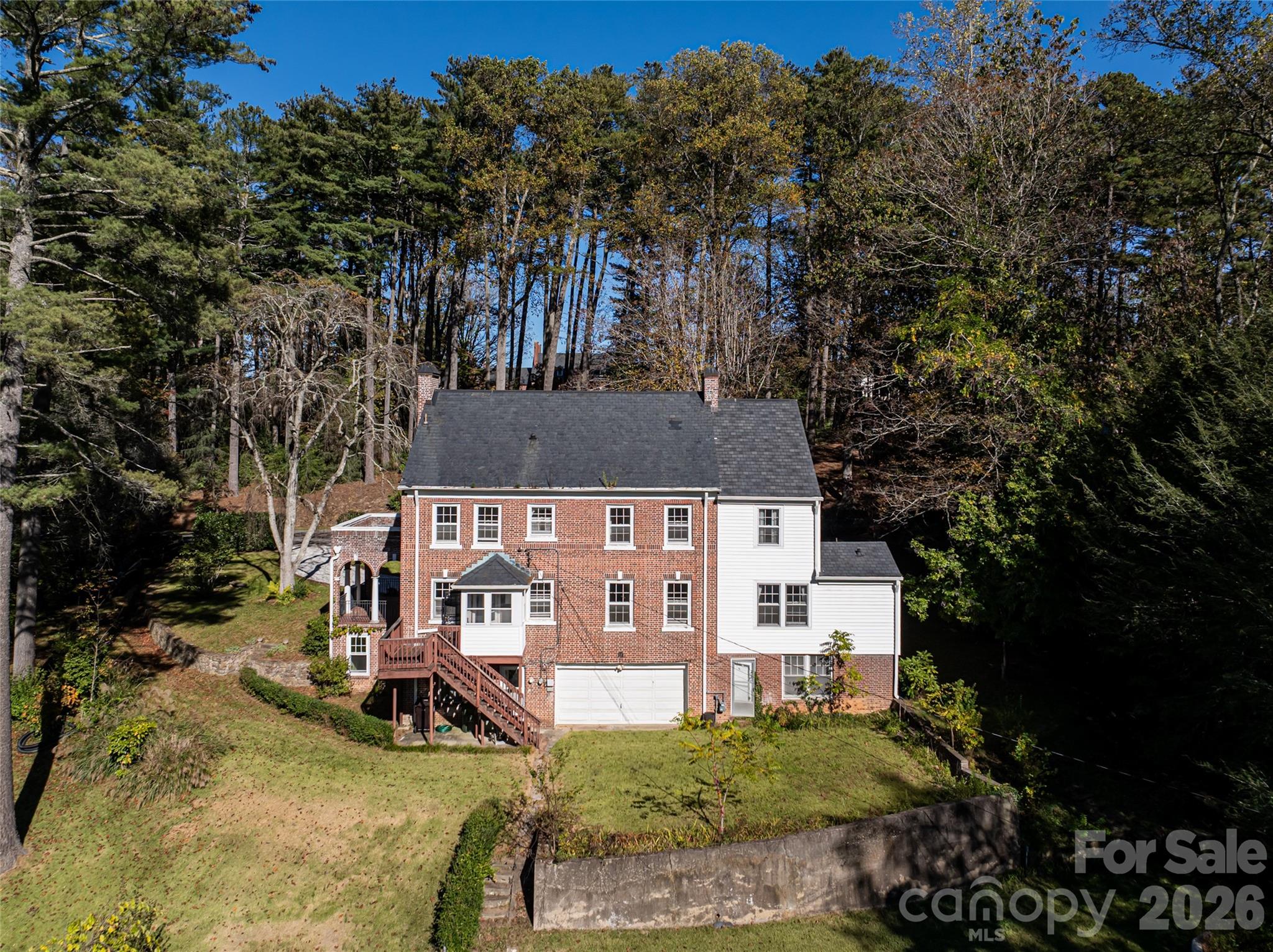 325 Vanderbilt Road Asheville, NC 28803 - Photo 36 of 48 an aerial view of a house with a yard table and chairs