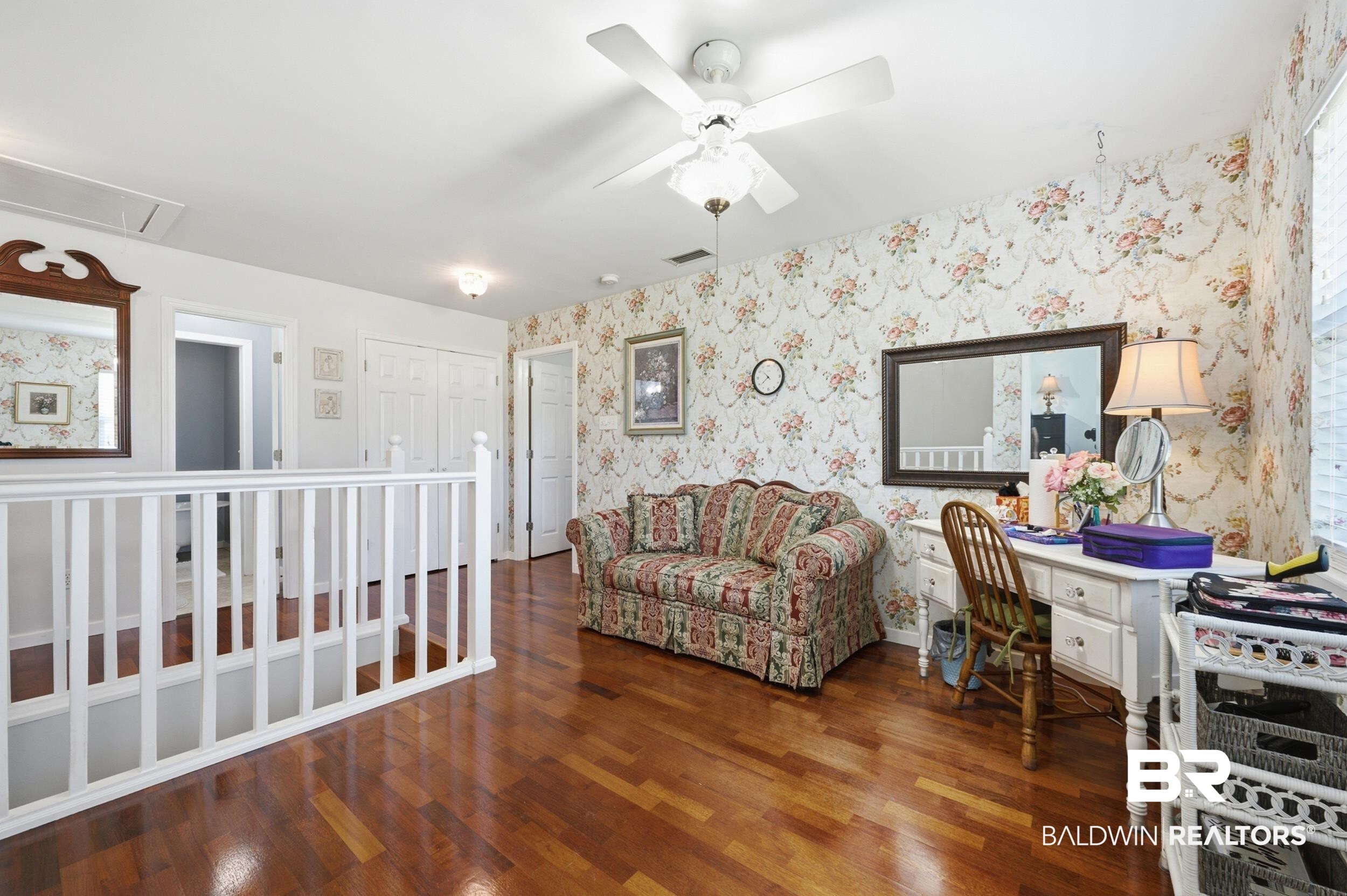 15855 Calvin Richerson Road Bay Minette, AL 36507 - Photo 52 of 83 Spacious upper-level landing featuring wood-finish flooring, white spindle railing, and a ceiling fan with light fixture