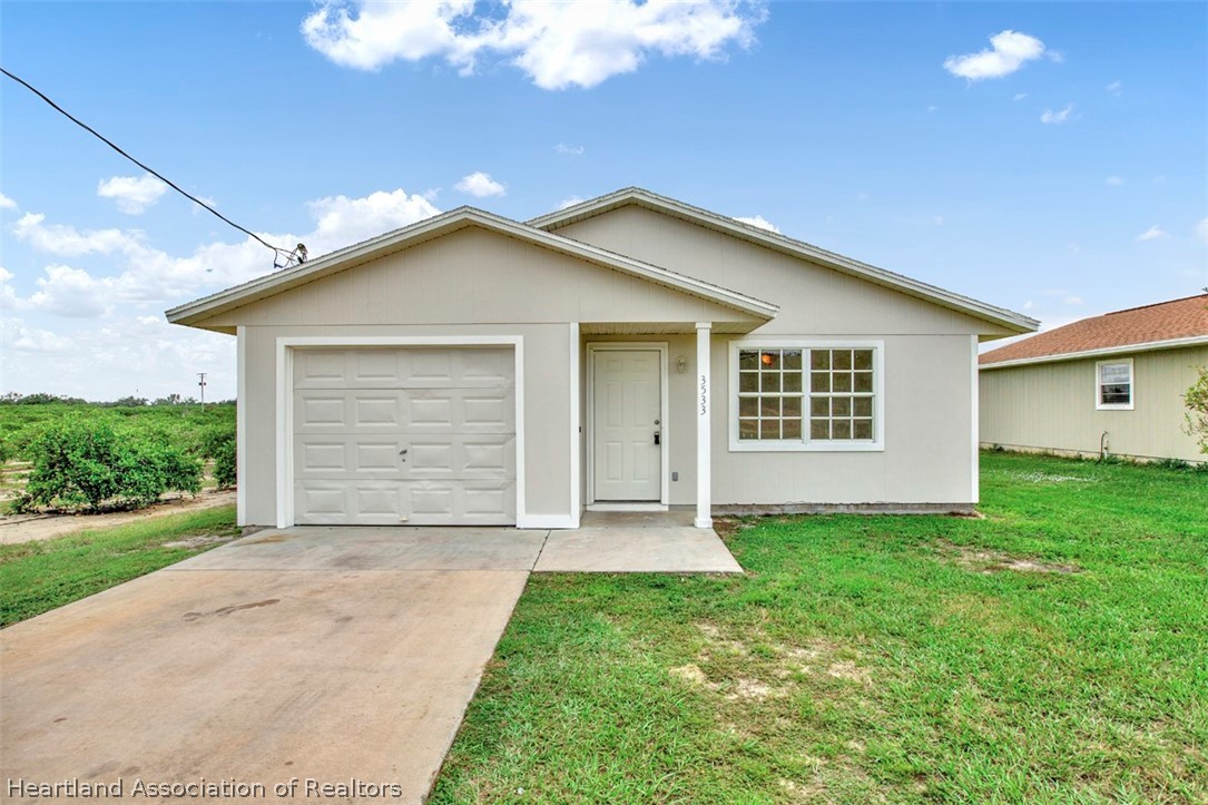 3533 Cemetery Road Sebring, FL 33870 - Photo 1 of 21 a view of a house with a yard and garage