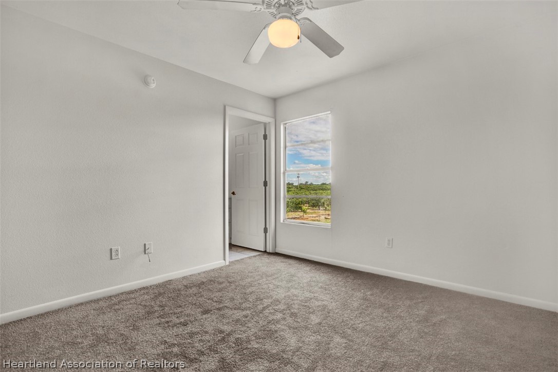 3533 Cemetery Road Sebring, FL 33870 - Photo 17 of 21 an empty room with windows and