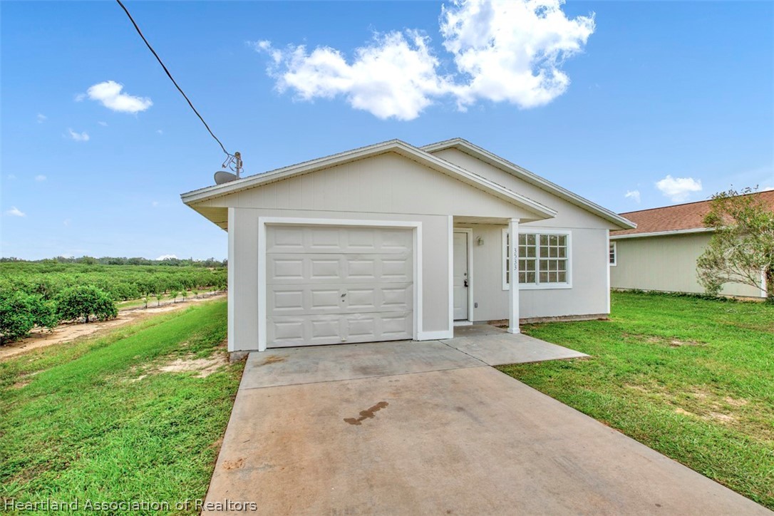 3533 Cemetery Road Sebring, FL 33870 - Photo 19 of 21 a view of a house with a yard