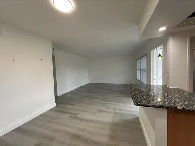 a view of a room with wooden floor