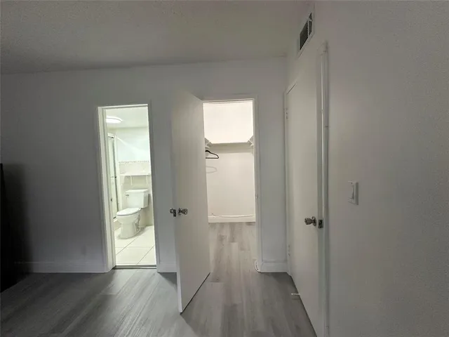 a view of a street with a cars parked in front of it