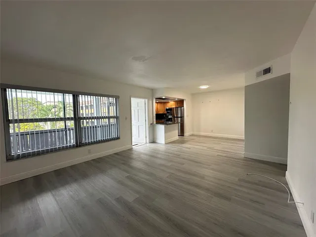 a kitchen with stainless steel appliances granite countertop sink stove and refrigerator