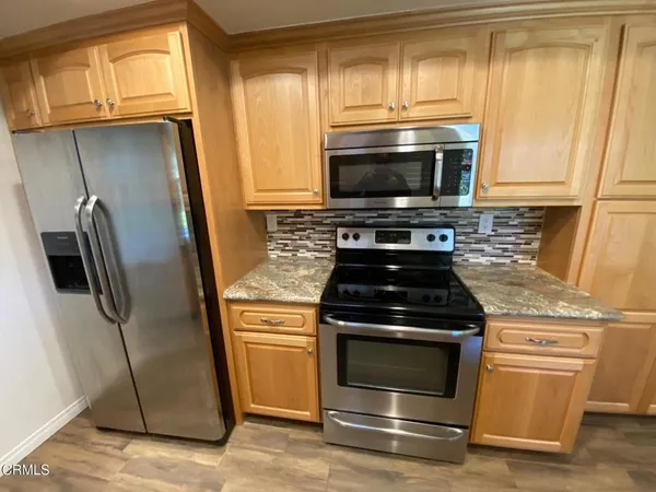 a kitchen with a stove microwave and refrigerator