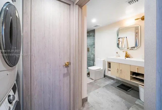 a spacious bathroom with a toilet a sink and a mirror