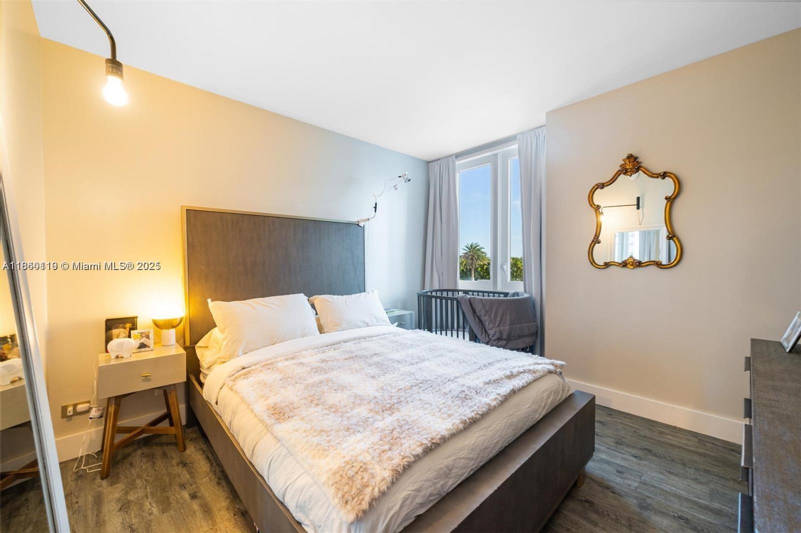 2301 Collins Avenue, Unit 306 Miami Beach, FL 33139 - Photo 14 of 27 a bedroom with a bed and a table in it