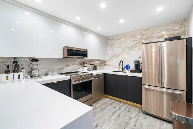 a kitchen with a refrigerator sink and wooden cabinets