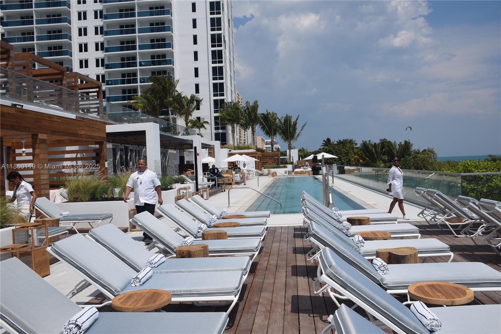 2301 Collins Avenue, Unit 306 Miami Beach, FL 33139 - Photo 25 of 27 a view of a patio with couches table and chairs with potted plants and big yard