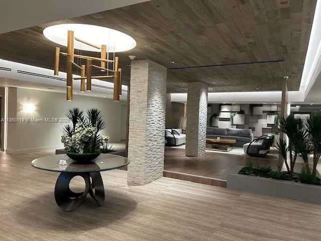 a living room with furniture and potted plants