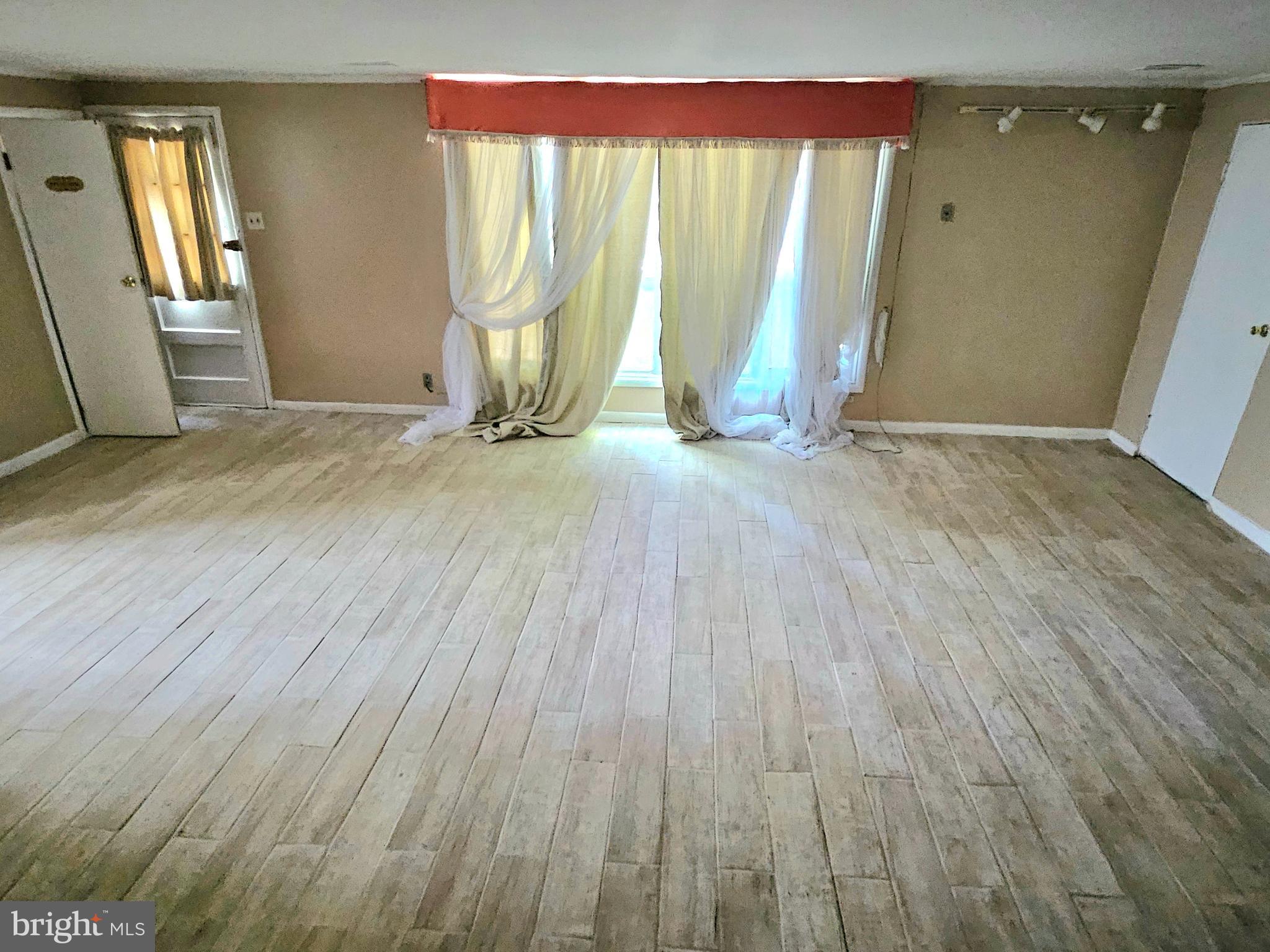 148 Church Road Elkins Park, PA 19027 - Photo 24 of 33 an empty room with wooden floor and windows