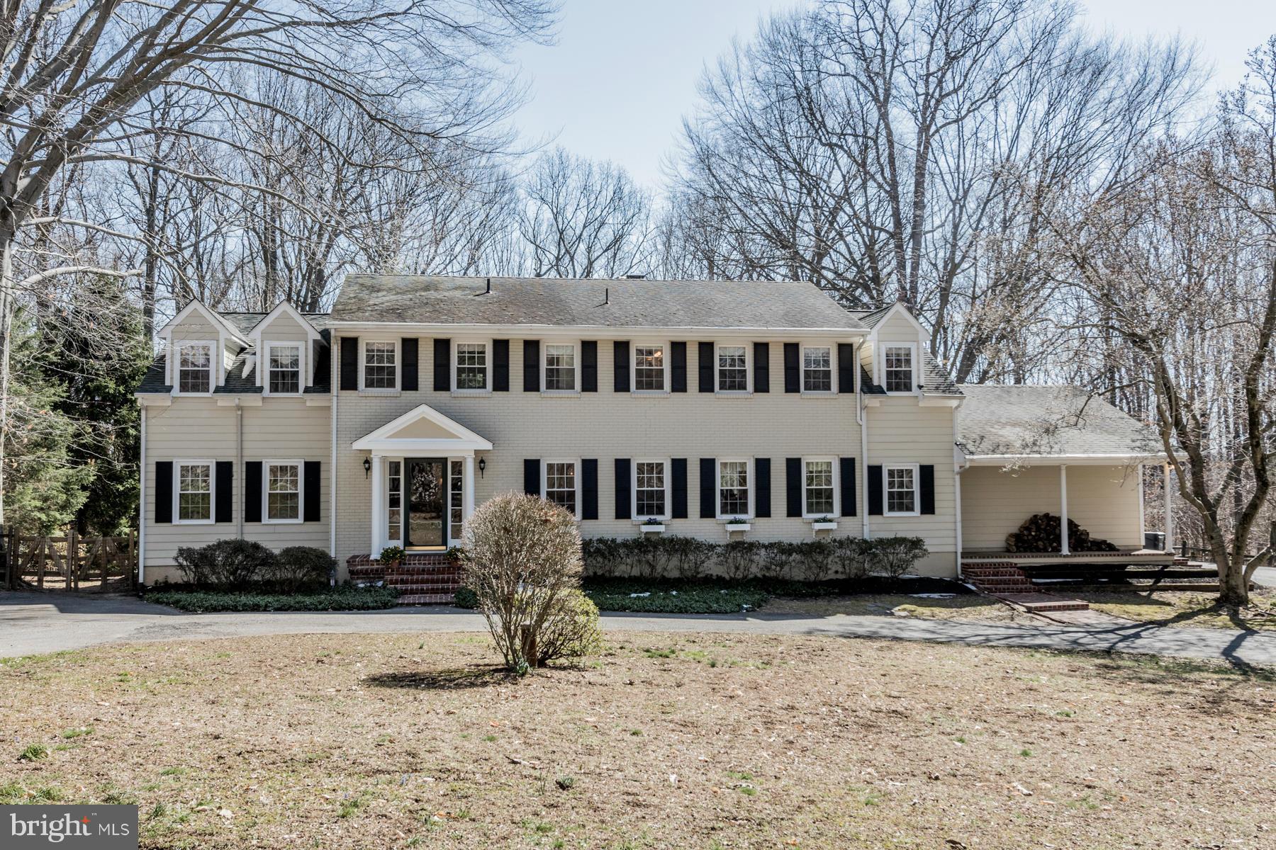 a front view of a house with a yard covered in snow