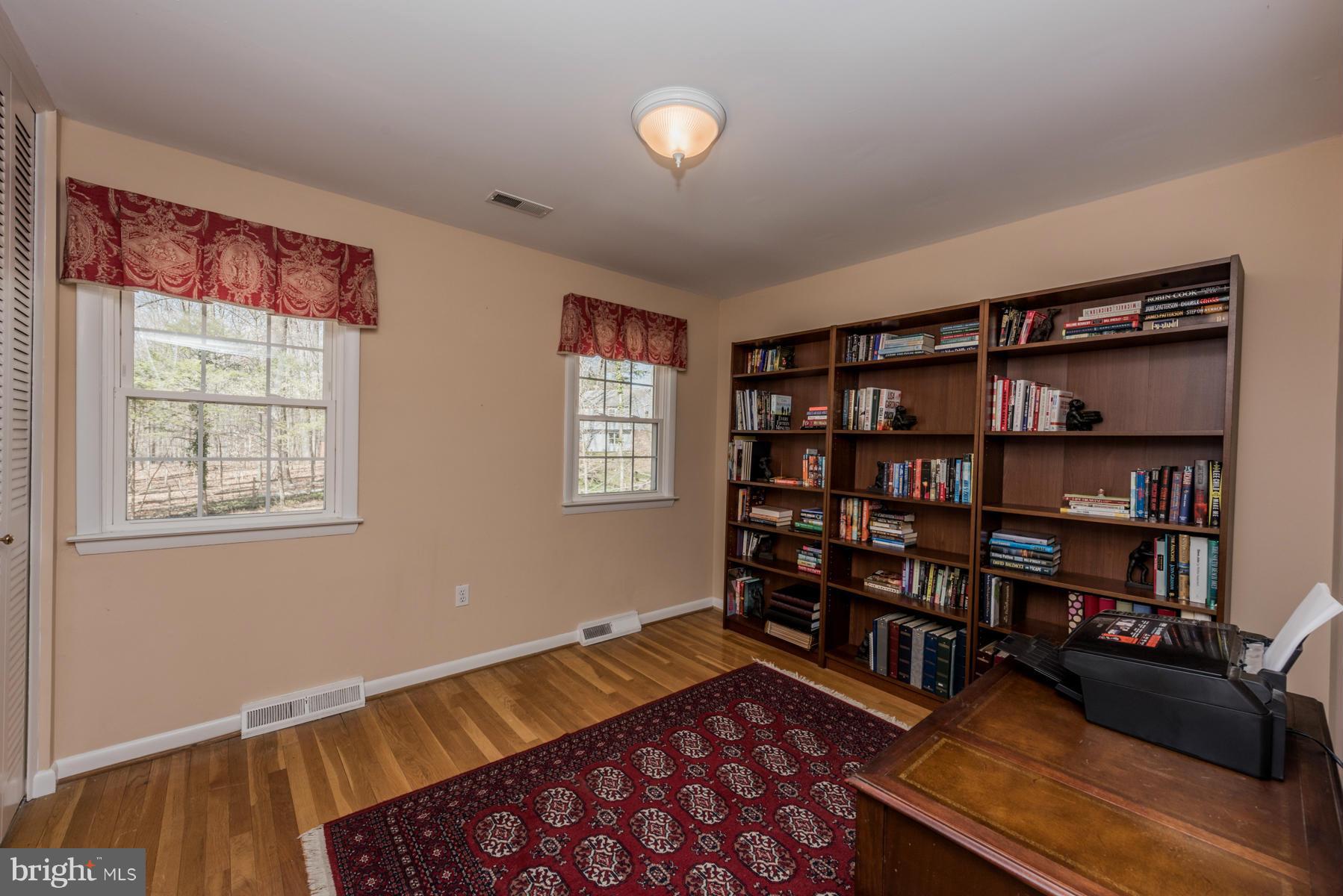 13602 Royal Crest Road Phoenix, MD 21131 - Photo 18 of 29 a bedroom with furniture and a book shelf
