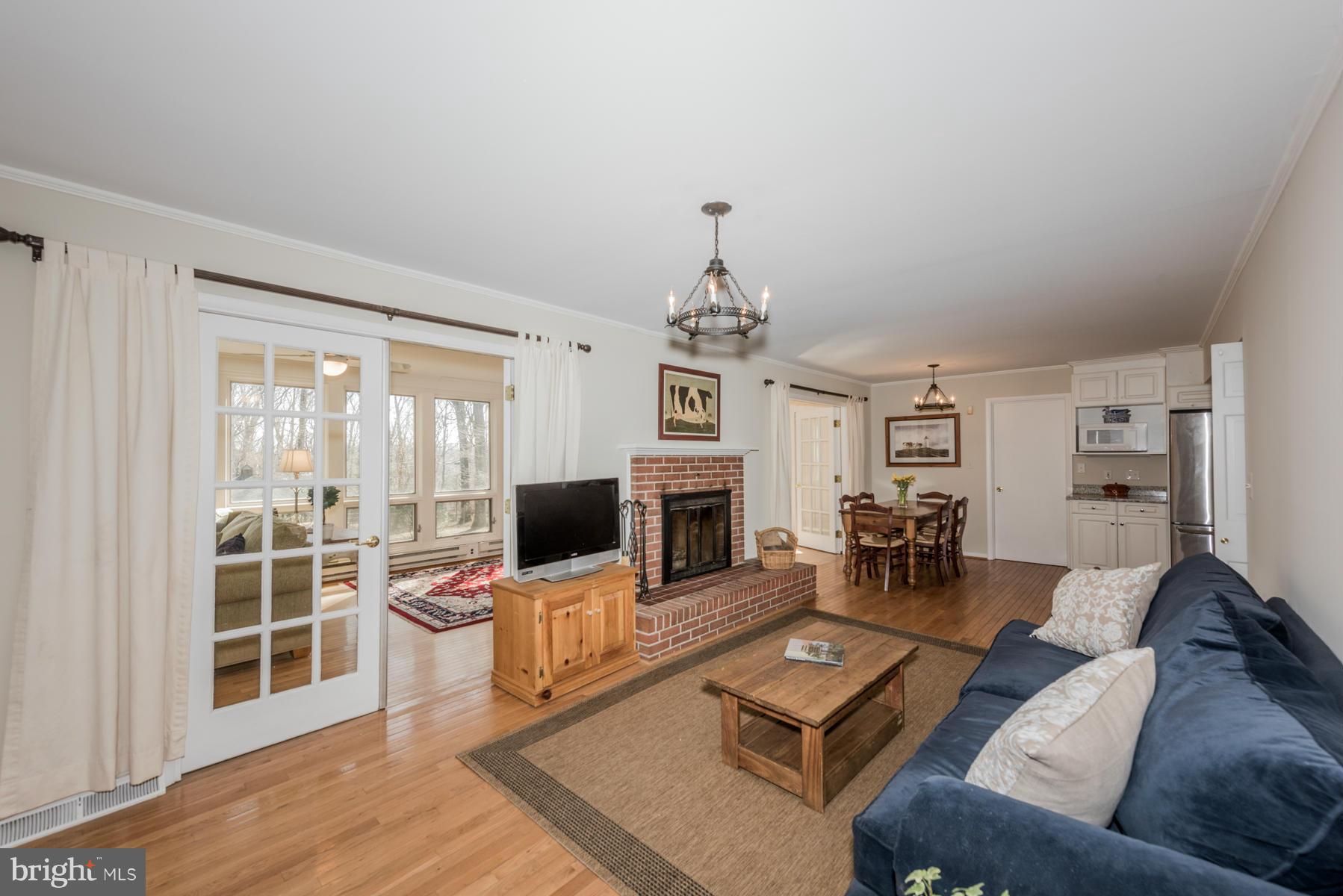 13602 Royal Crest Road Phoenix, MD 21131 - Photo 7 of 29 a living room with furniture a fireplace and a flat screen tv