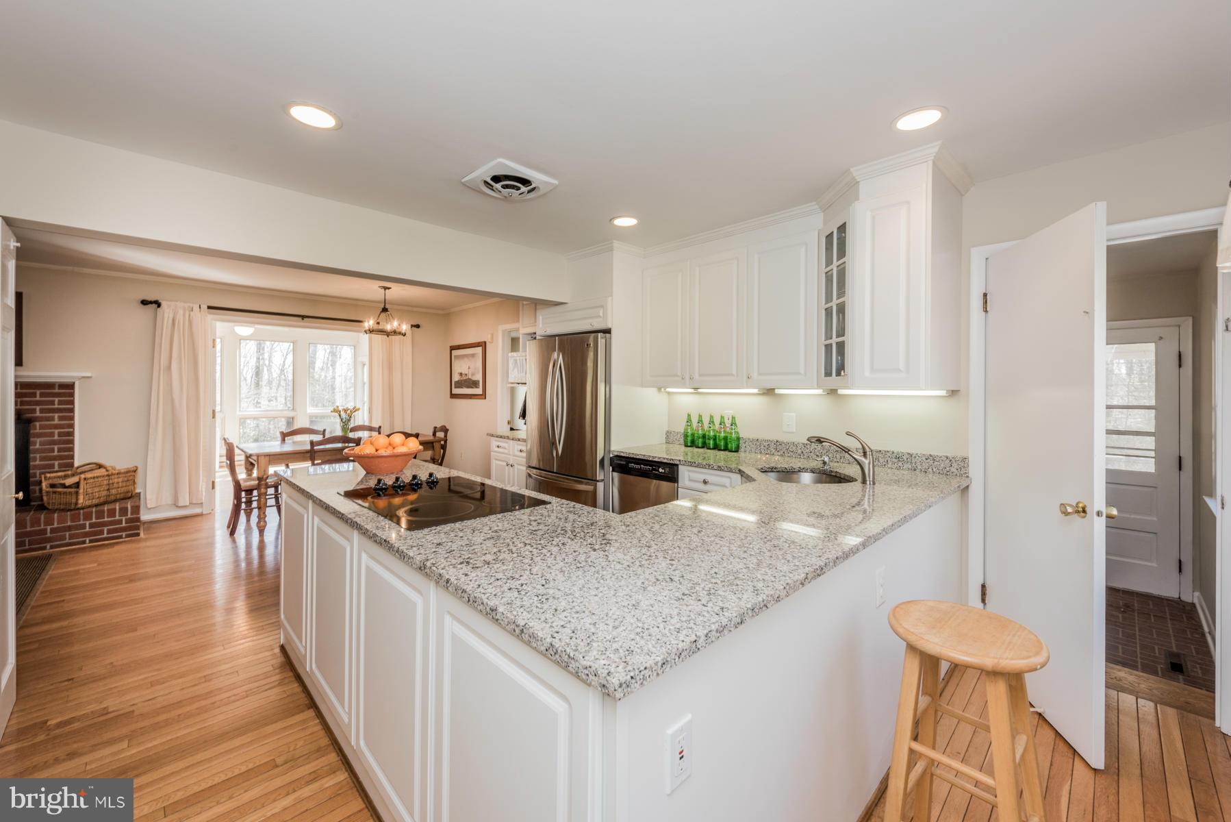 13602 Royal Crest Road Phoenix, MD 21131 - Photo 9 of 29 a kitchen with granite countertop kitchen island stainless steel appliances a sink and living room view