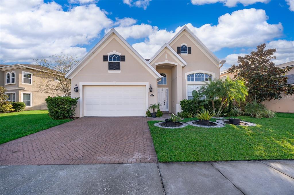 637 Spring Oak Circle Orlando, FL 32828 - Photo 1 of 1 a front view of a house with a yard and garage