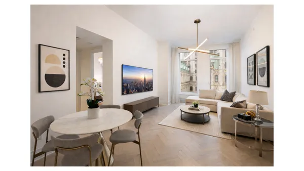 a living room with furniture a chandelier and a flat screen tv