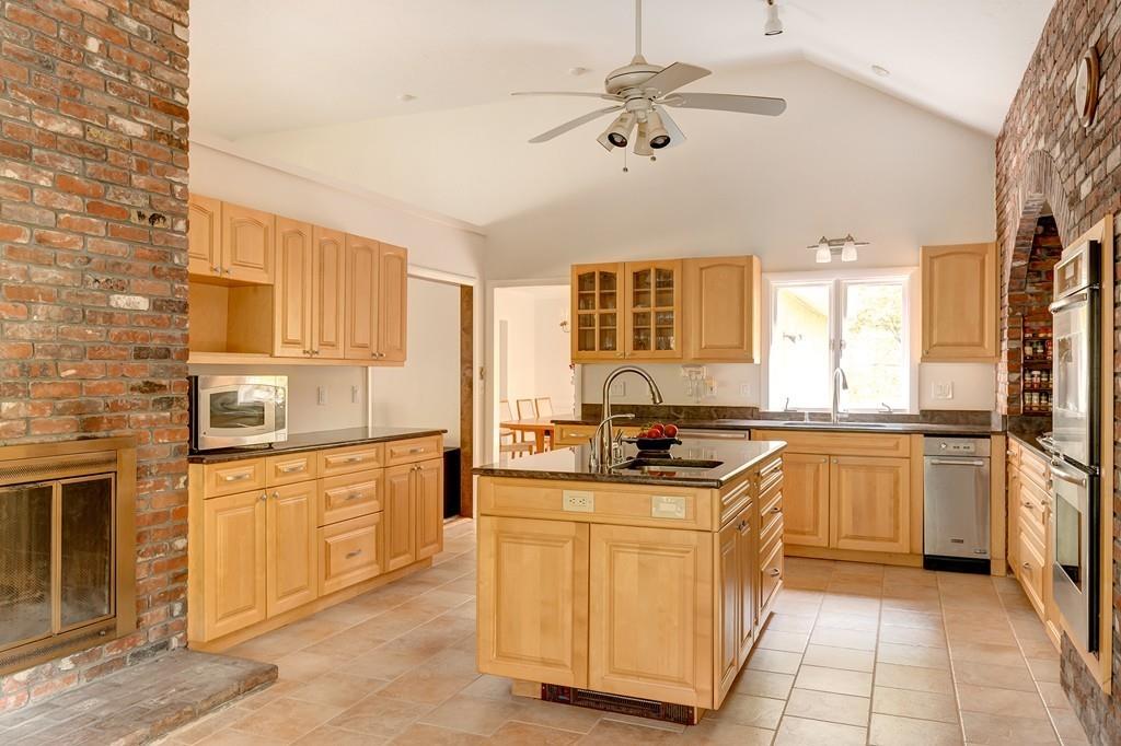 33 Laxfield Road Weston, MA 02493 - Photo 5 of 21 a kitchen with stainless steel appliances granite countertop a stove a sink and a refrigerator