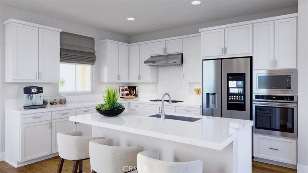 1201 Windmill Road Rancho Mission Viejo, CA 92694 - Photo 1 of 1 a kitchen with white cabinets and stainless steel appliances
