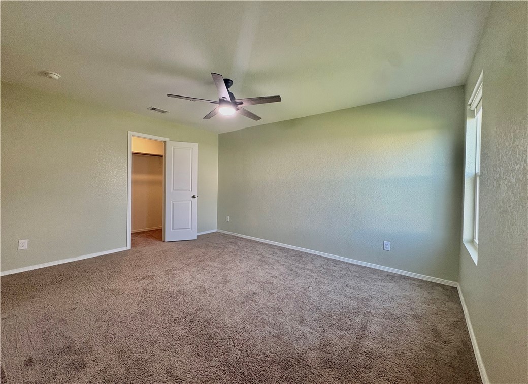 1109 Demeter Drive Portland, TX 78374 - Photo 10 of 18 an empty room with a ceiling fan and a window