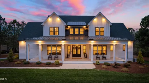 a bathroom with a granite countertop sink toilet mirror and shower