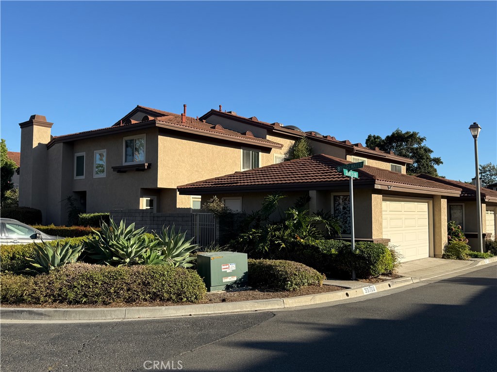 33706 Surfside Drive, Unit 146 Dana Point, CA 92629 - Photo 1 of 17 a front view of a house with a yard