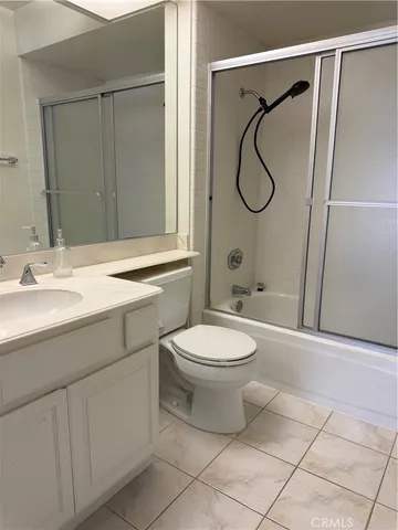 a bathroom with a toilet sink vanity and mirror