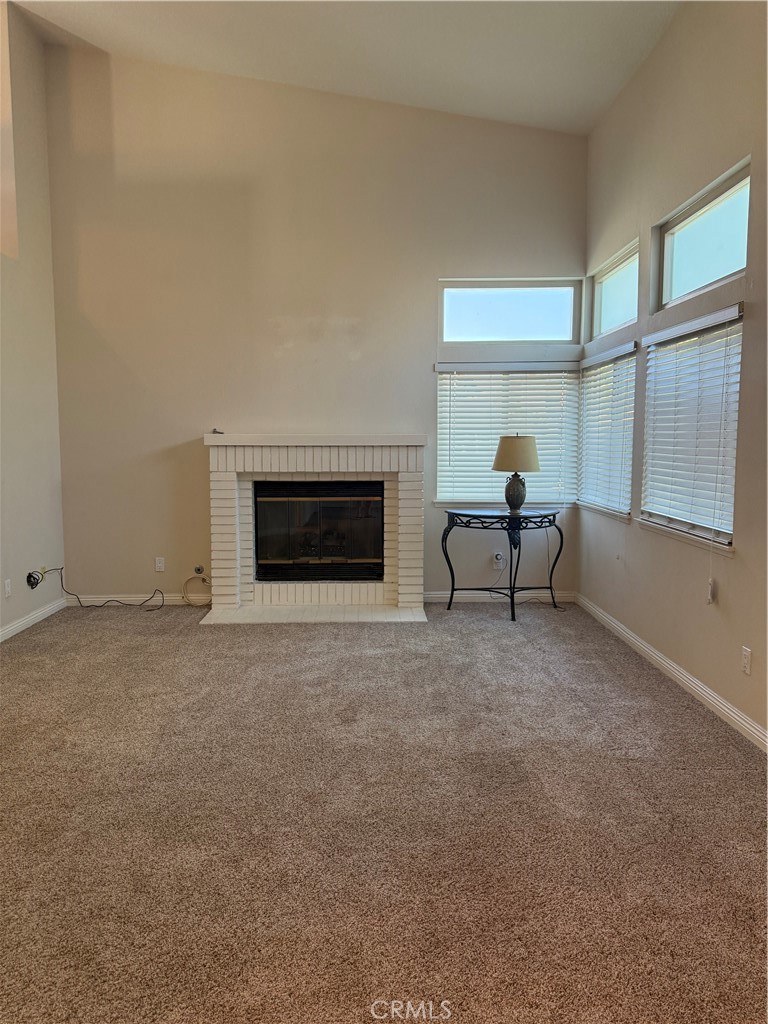 33706 Surfside Drive, Unit 146 Dana Point, CA 92629 - Photo 6 of 17 a living room with furniture and a fireplace