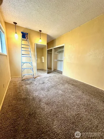 a bathroom with a granite countertop toilet sink and mirror