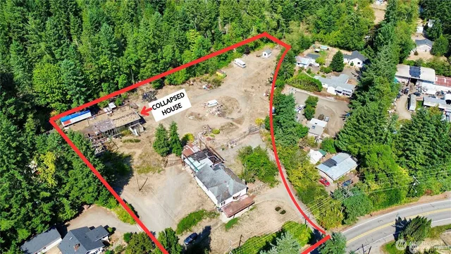 an aerial view of a house with table and chairs