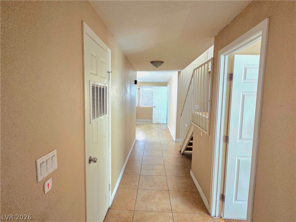 3648 Bronco Road Las Vegas, NV 89103 - Photo 5 of 24 An inviting foyer showcases warm-toned walls, durable tile flooring, and convenient stair access to upper levels.