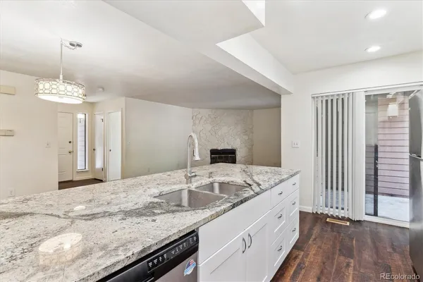 a bathroom with a granite countertop sink a large mirror and vanity