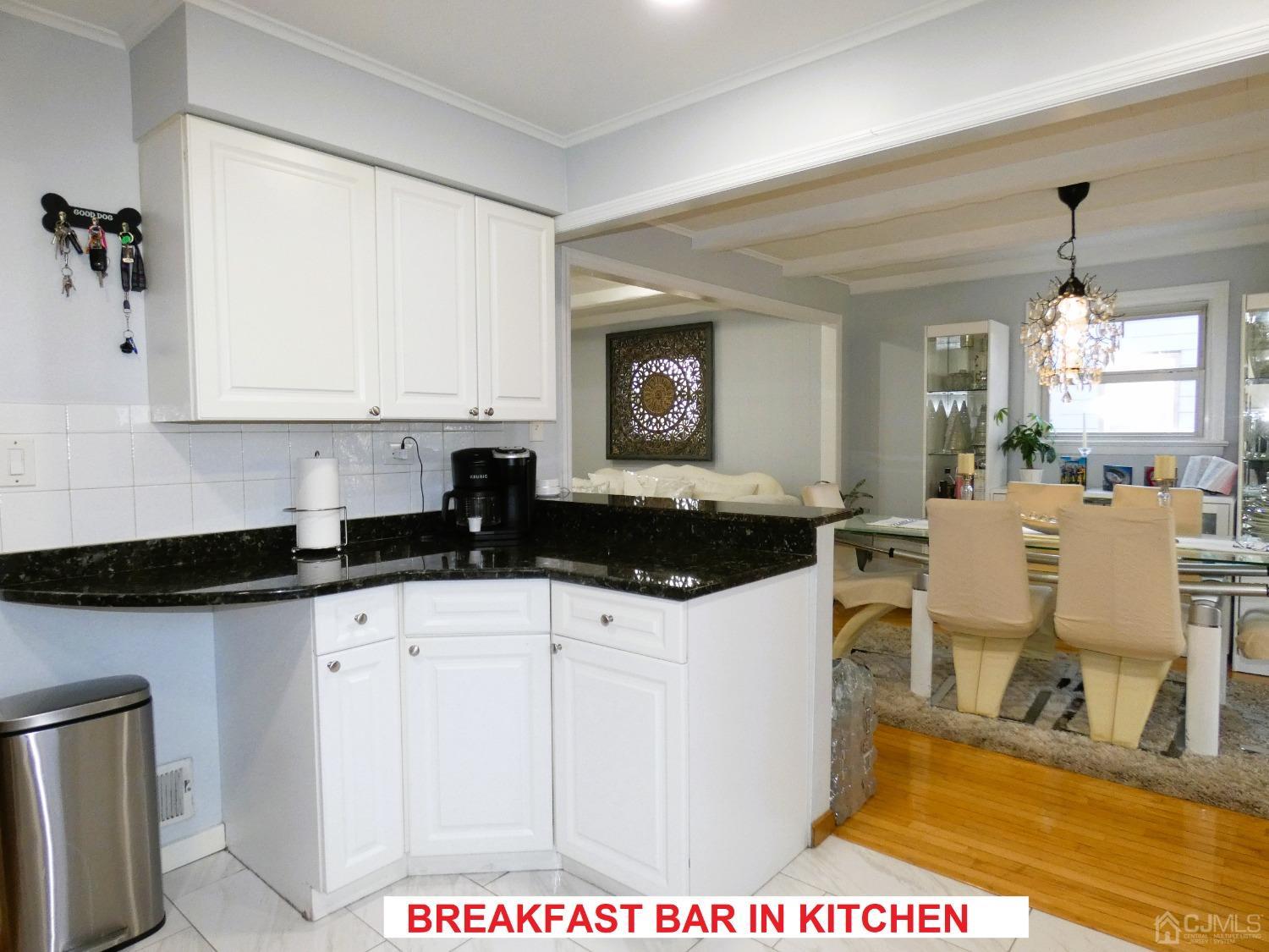 412 Chain O' Hills Road Colonia, NJ 07067 - Photo 11 of 34 a kitchen with granite countertop a sink and white cabinets