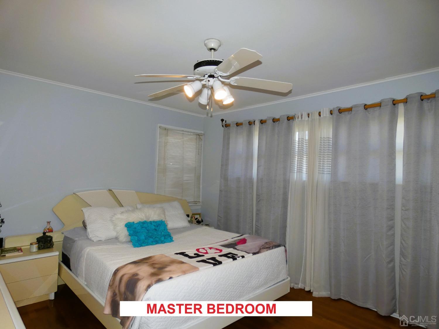 412 Chain O' Hills Road Colonia, NJ 07067 - Photo 12 of 34 a bed sitting in a bedroom next to a window