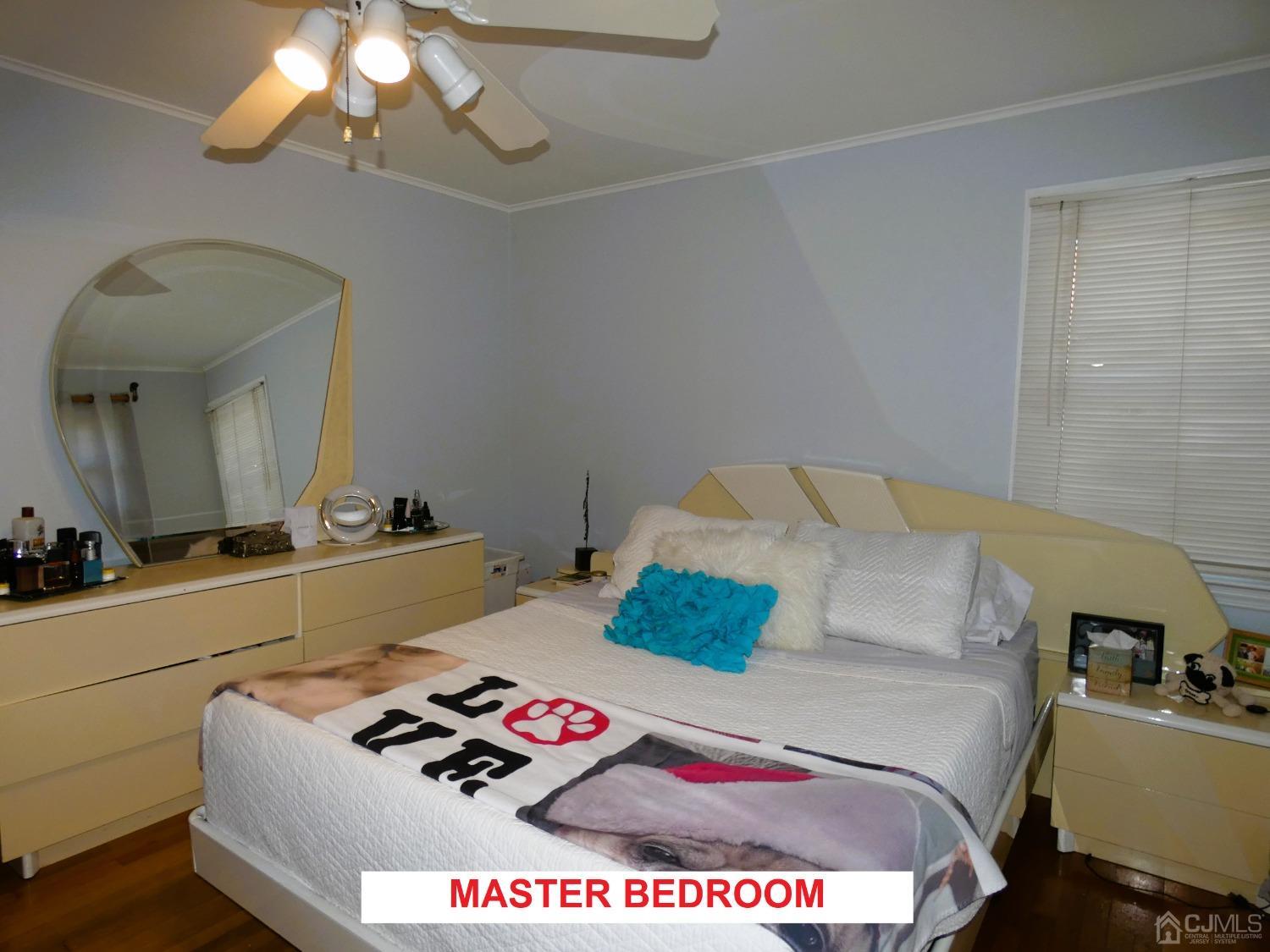 412 Chain O' Hills Road Colonia, NJ 07067 - Photo 13 of 34 a bedroom with a bed and a chandelier