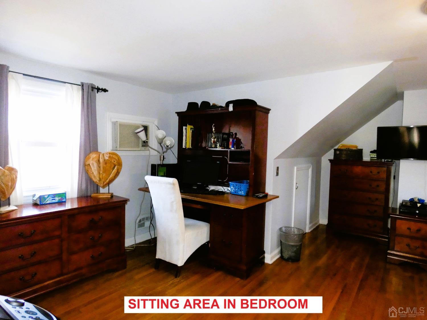 412 Chain O' Hills Road Colonia, NJ 07067 - Photo 15 of 34 a living room with furniture and a flat screen tv