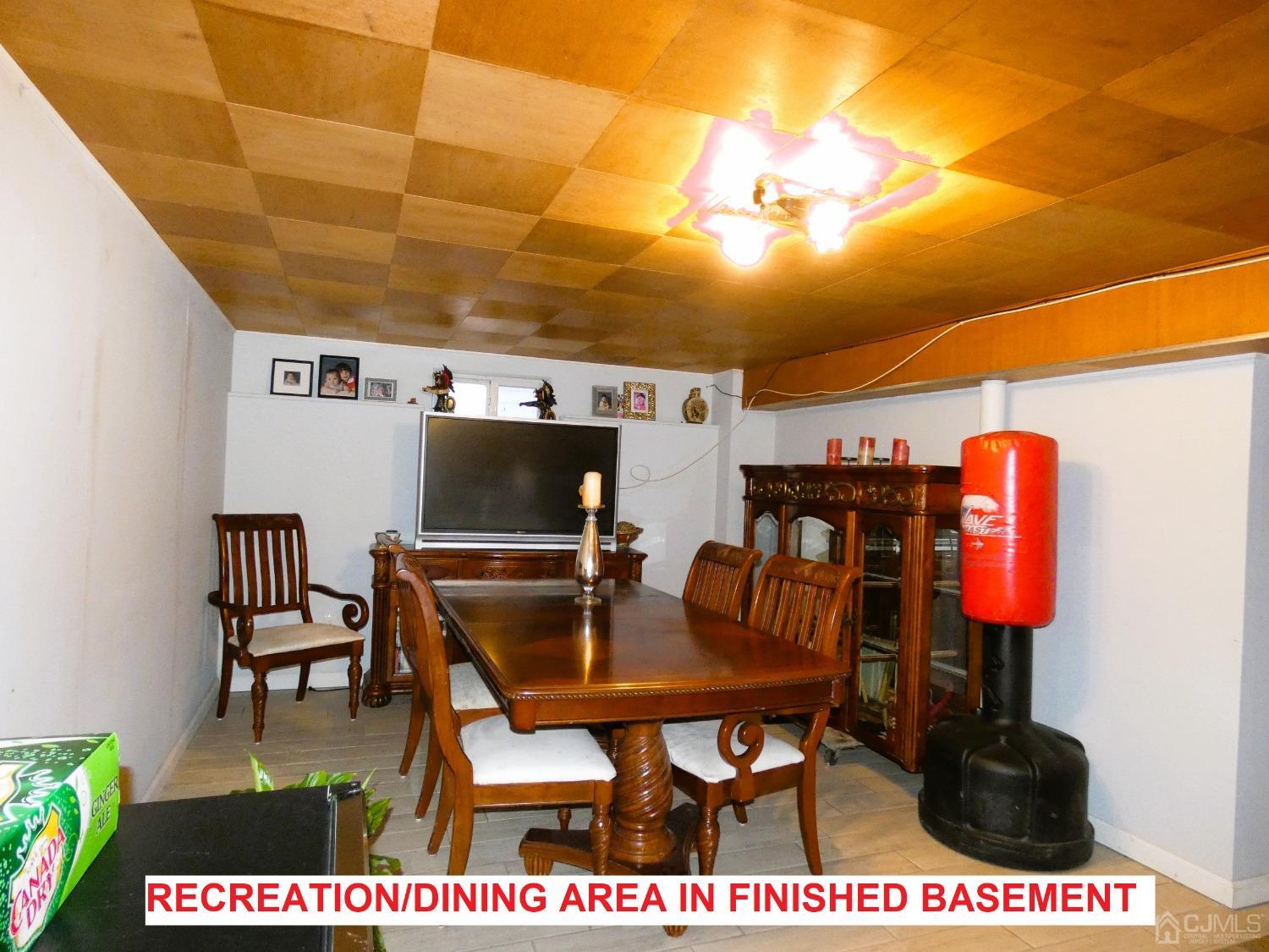 412 Chain O' Hills Road Colonia, NJ 07067 - Photo 18 of 34 a dining room with furniture and a floor to ceiling window