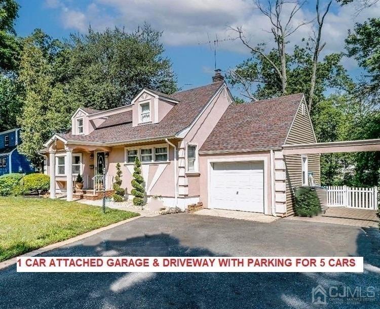 412 Chain O' Hills Road Colonia, NJ 07067 - Photo 2 of 34 a view of a white house with a small yard and a garden