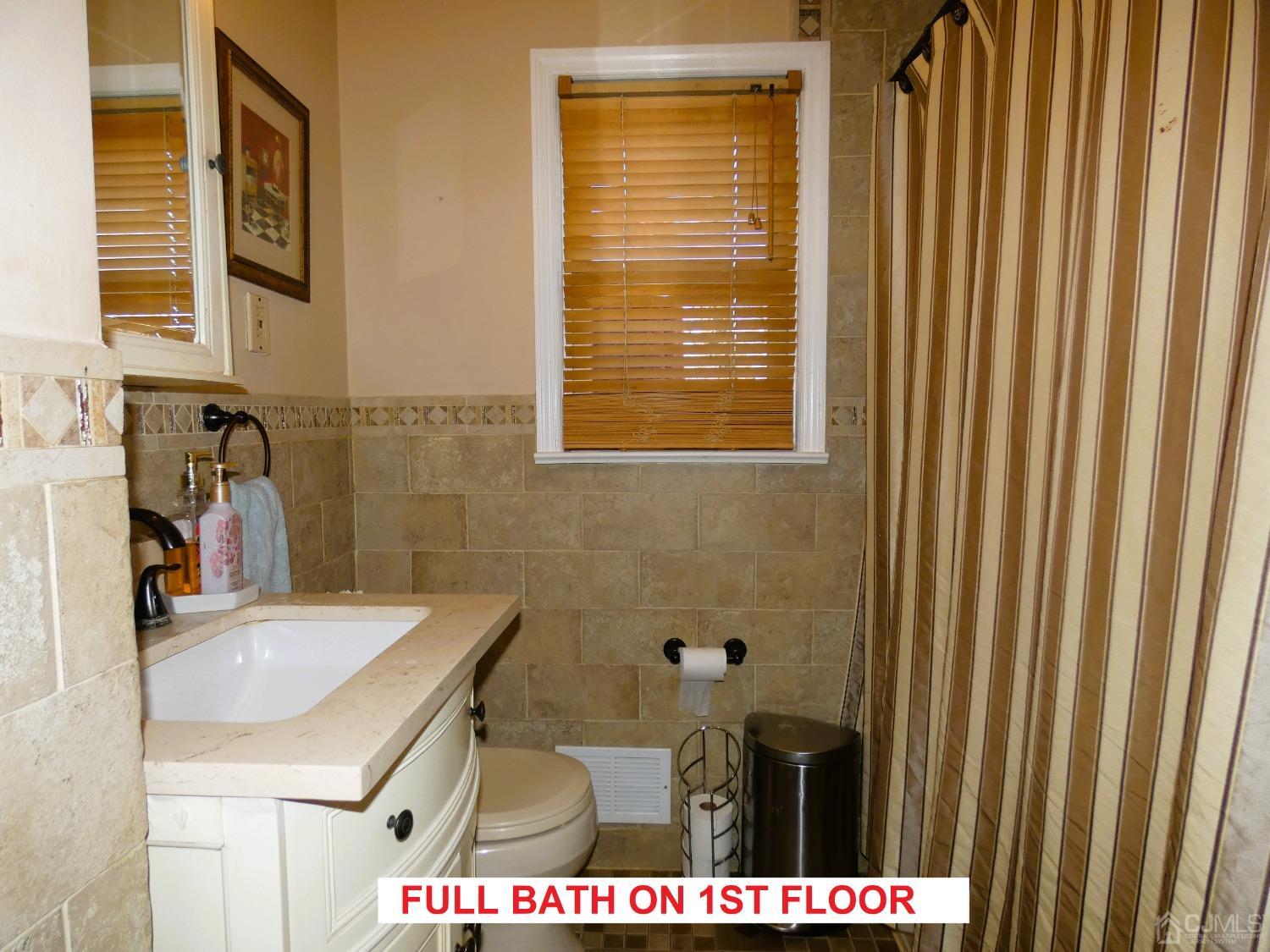 412 Chain O' Hills Road Colonia, NJ 07067 - Photo 21 of 34 a bathroom with a sink and a mirror