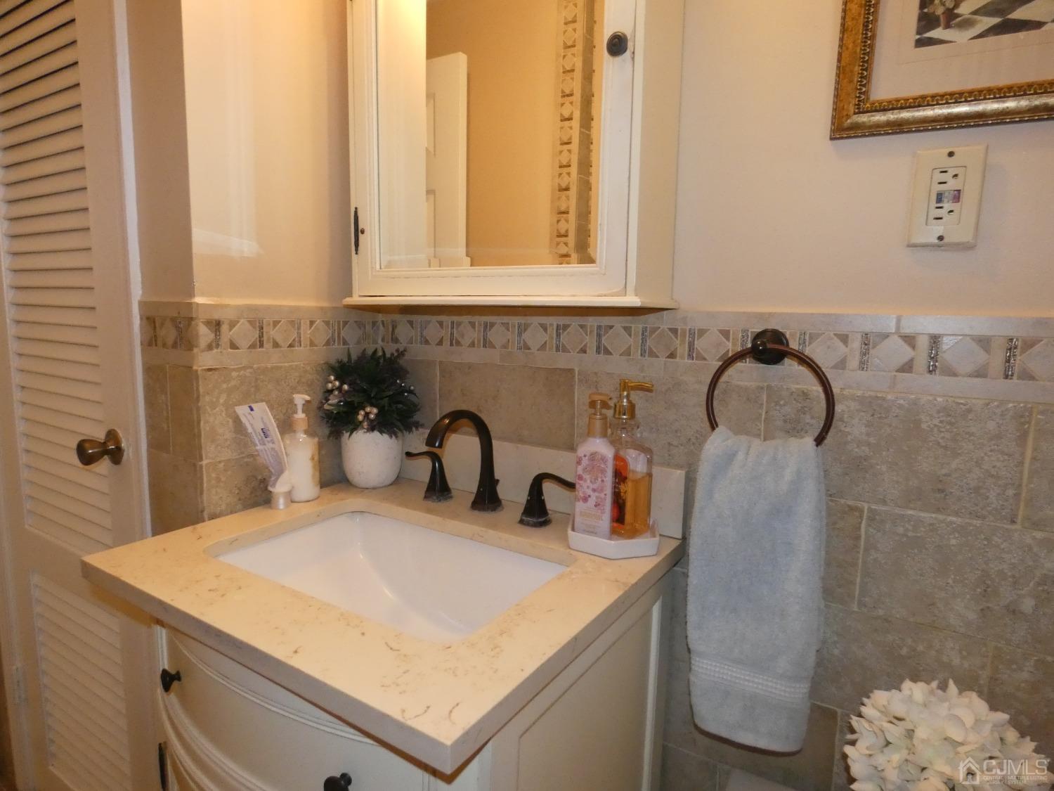 412 Chain O' Hills Road Colonia, NJ 07067 - Photo 22 of 34 a bathroom with a sink and a mirror